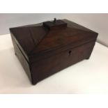 A WOODEN BOX WITH BRASS FEET AND TOP