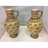 A PAIR OF TALL CERAMIC DECORATIVE SINGLE HANDLED JUGS HEIGHT 34CM