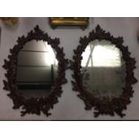 A PAIR OF HEAVY MATCHING WALL MIRRORS WITH ORNATE LEAF DESIGN