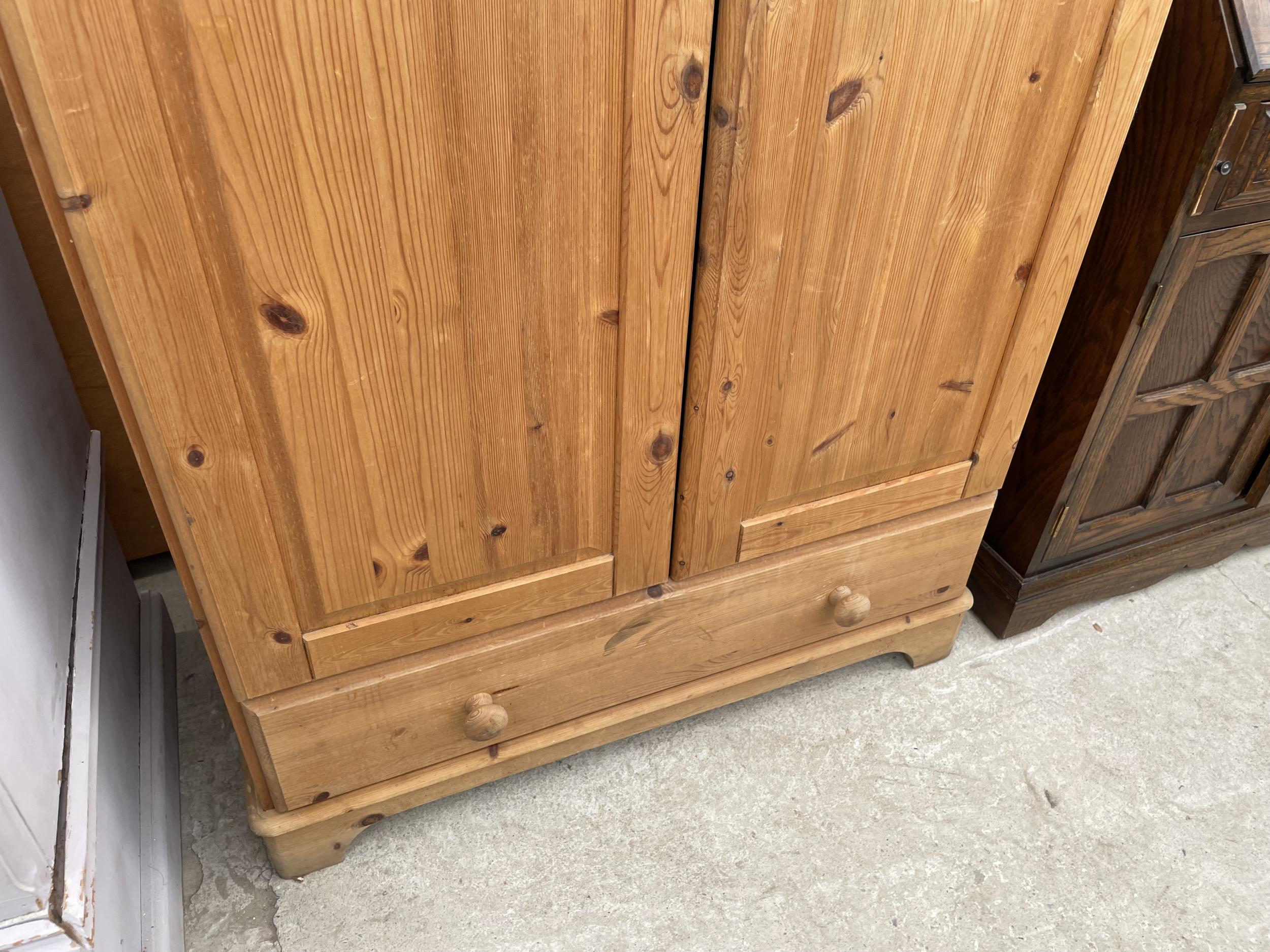 A MODERN PINE TWO DOOR WARDROBE WITH A DRAWER TO THE BASE AND TOP BOX 35" WIDE - Image 4 of 4