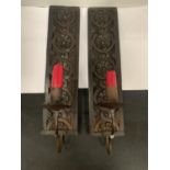 A PAIR OF MATCHING WALL MOUNTED CANDLE HOLDERS WITH ORNATE CARVED WOODEN BACKS