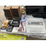 AN ASSORTMENT OF ITEMS TO INCLUDE SPEAKERS, THREE PSP GAMES CONSOLES AND A BROTHER TYPEWRITER ETC