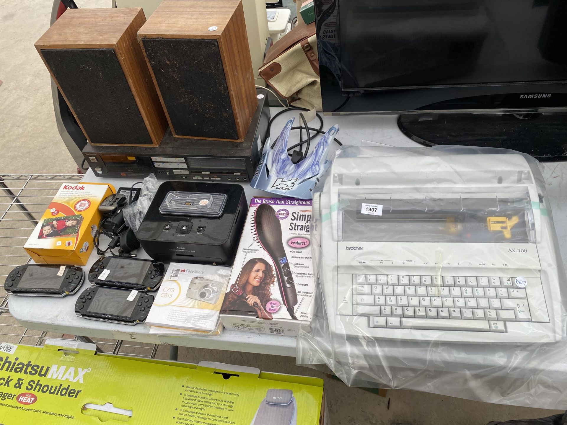 AN ASSORTMENT OF ITEMS TO INCLUDE SPEAKERS, THREE PSP GAMES CONSOLES AND A BROTHER TYPEWRITER ETC