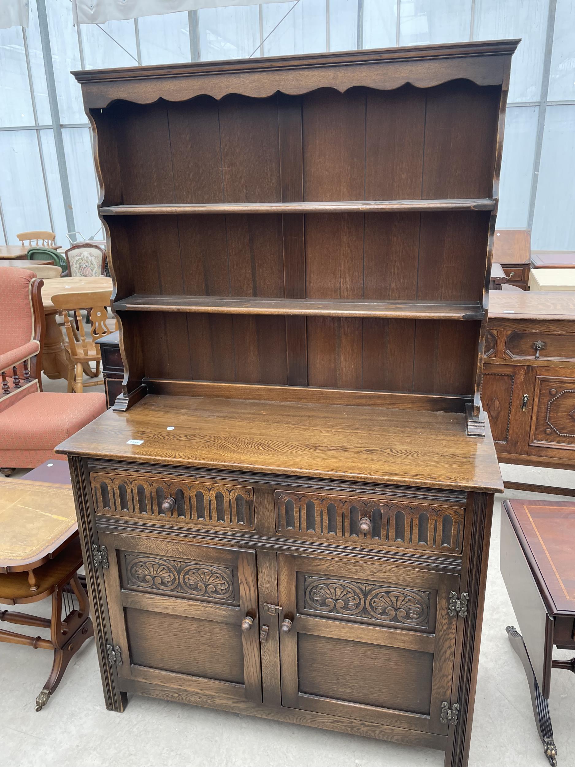 AN OAK OLD CHARM STYLE DRESSER WITH PLATE RACK 42" WIDE