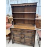 AN OAK OLD CHARM STYLE DRESSER WITH PLATE RACK 42" WIDE