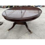 A 19TH CENTURY STYLE MAHOGANY DINING TABLE 60" DIAMETER ON BRASS LION PAW FEET