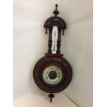 AN ORNATE WALL BAROMETER