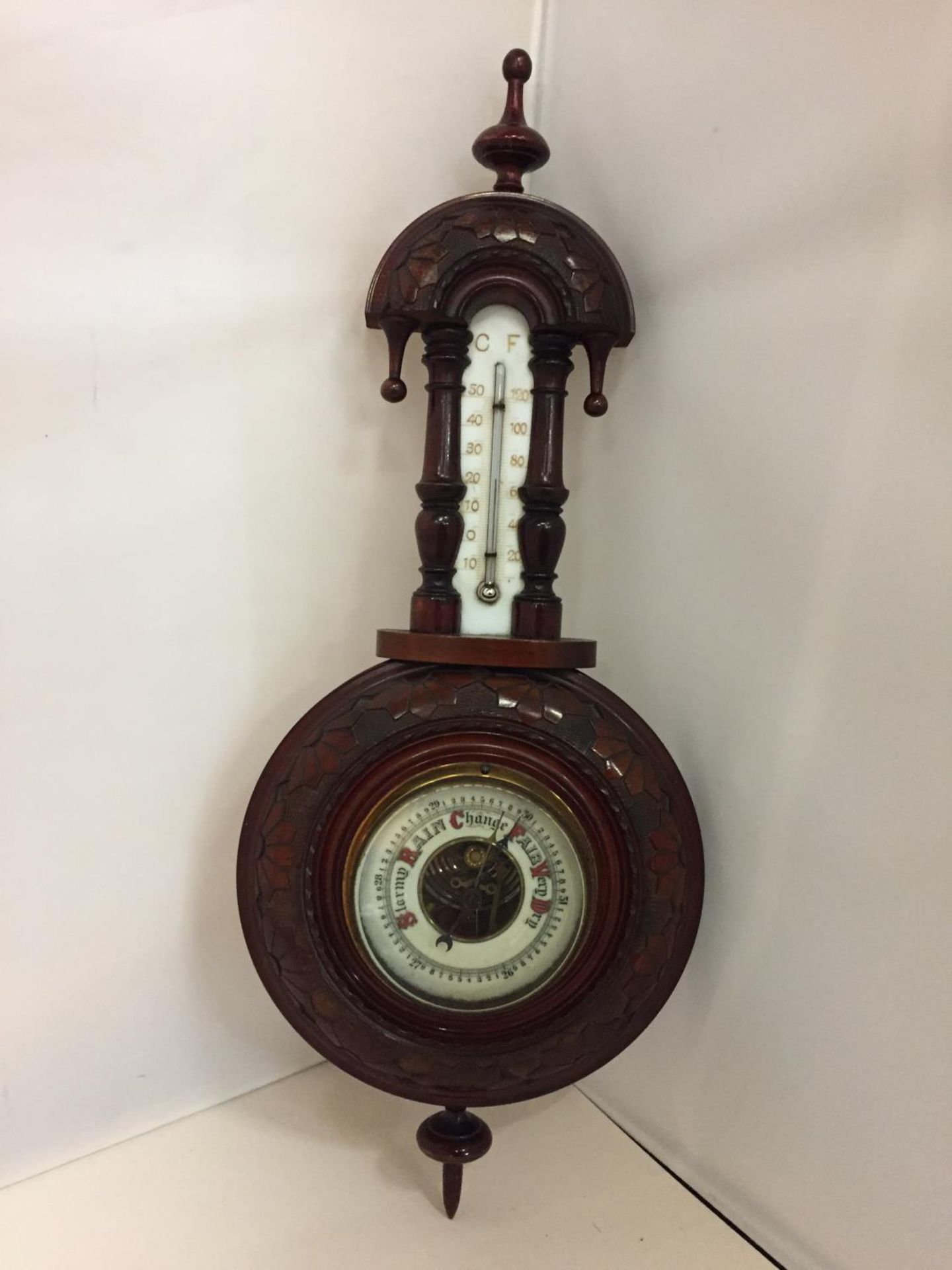 AN ORNATE WALL BAROMETER