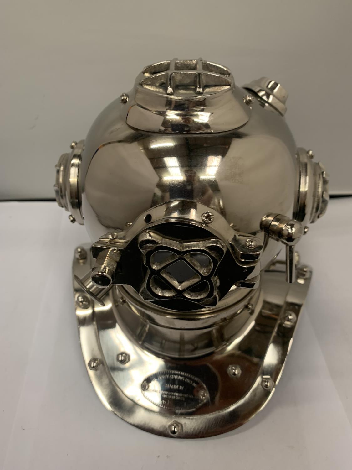 A CHROME MODEL OF A DIVERS HELMET