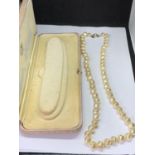 A PEARL NECKLACE IN A PRESENTATION BOX