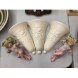 THREE CREAM CERAMIC WALL VASES AND TWO FURTHER WALL VASES WITH CHERUBS