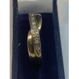 A 9 CARAT GOLD TWIST RING WITH IN LINE DIAMONDS IN A PRESENTATION BOX