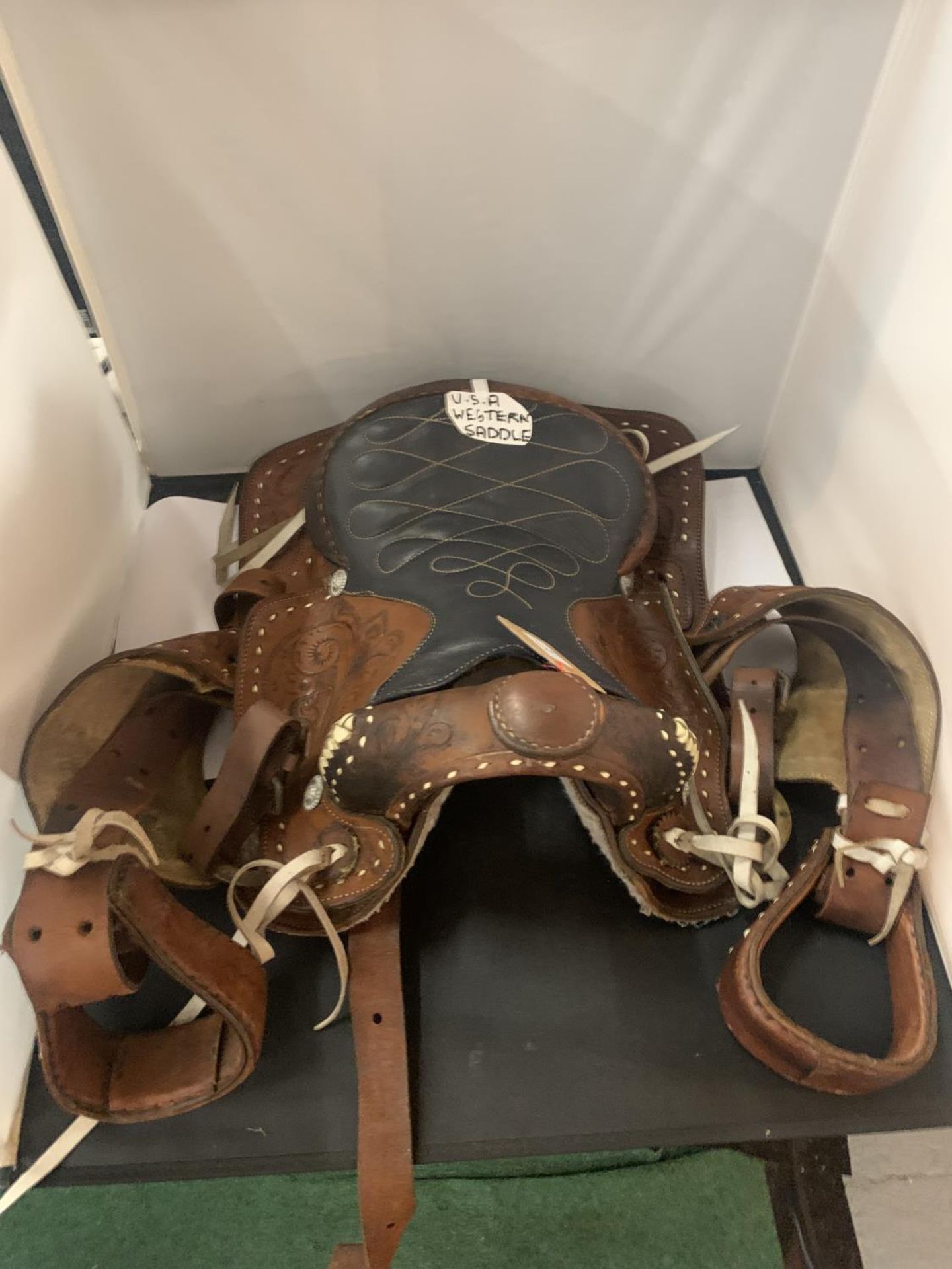 A TAN AND BLACK LEATHER U.S.A. WESTERN SADDLE WITH DECORATIVE DESIGNS AND STITCHING TOGETHER WITH - Image 2 of 6