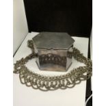 A SILVER PLATED LIDDED TEA CADDY AND AN ORNATE WHITE METAL BELT