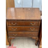 AN EDWARDIAN MAHOGANY BUREAU ON CABRIOLE LEGS 30" WIDE