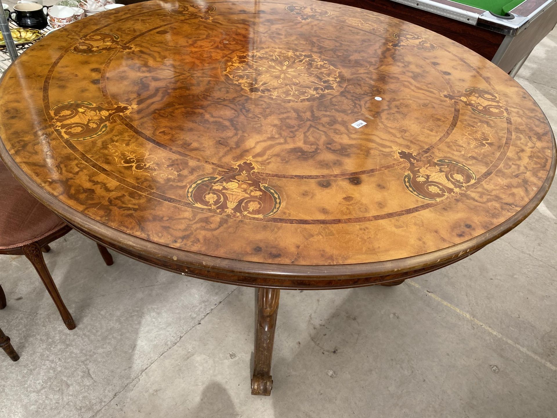 A VICTORIAN STYLE WALNUT AND INLAID LOO TYPE TABLE ON A QUARTETTO BASE 59" WIDE
