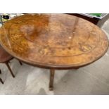 A VICTORIAN STYLE WALNUT AND INLAID LOO TYPE TABLE ON A QUARTETTO BASE 59" WIDE