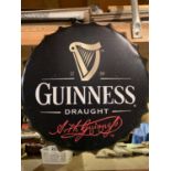 A VINTAGE STYLE GUINNESS BOTTLE CAP DISPLAY SIGN