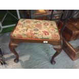 A DRESSING TABLE STOOL WITH A FLORAL TAPESTRY SEAT ON CABRIOLE LEGS