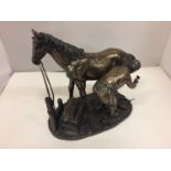 A RESIN FIGURINE OF A HORSE AND FARRIER HEIGHT 26CM