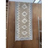 A TRIBAL KALIM FRINGED CARPET RUNNER