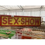 AN ILLUMINATED 'SEX-SHOW' SIGN