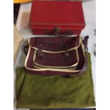 A SMALL RED CASE AND A SMALL BURGUNDY SCHOOL SATCHEL