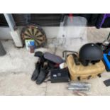 AN ASSORTMENT OF ITEMS TO INCLUDE A MOTOR BIKE HELMET, A DART BOARD AND A VISOR ETC