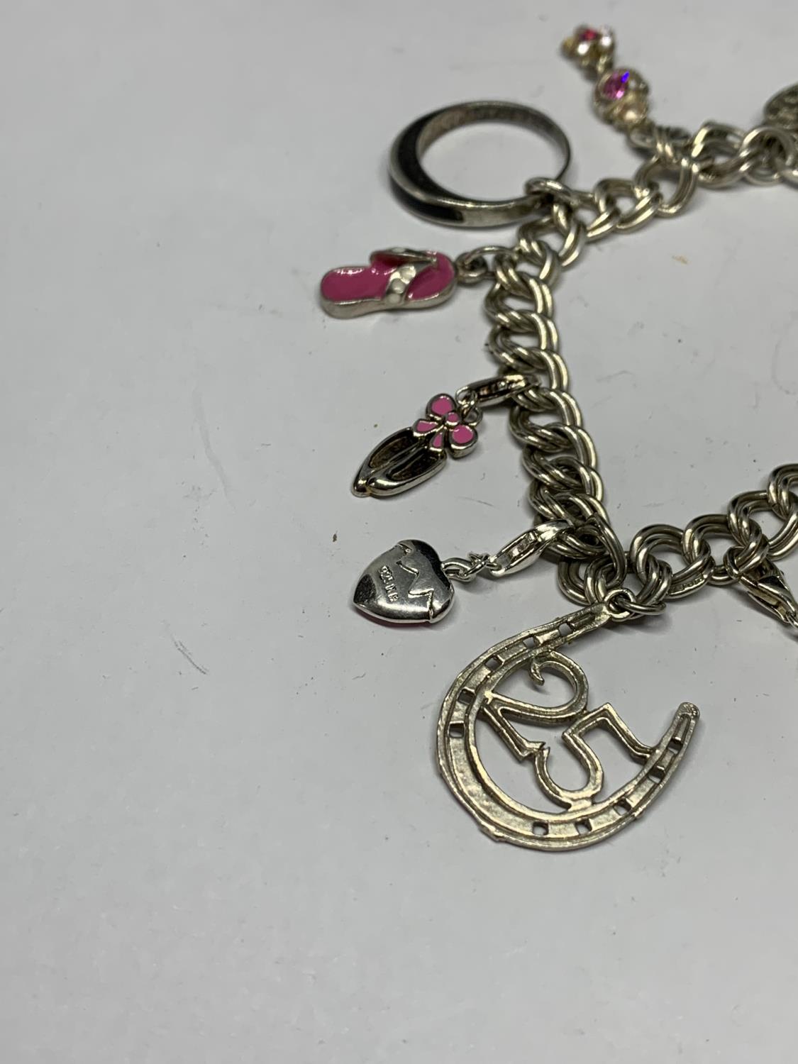 A SILVER CHARM BRACELET WITH ELEVEN CHARMS TO INCLUDE A BALLERINA, BALLET SHOES, DOG ETC - Bild 2 aus 3