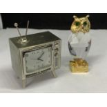 A WHITE METAL CLOCK IN TH FORM OF A TELEVISION SEEN WORKING BUT NO WARRANTY AND A GILT AND CRYSTAL