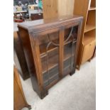 AN EARLY 20TH CENTURY OAK TWO DOOR GLAZED CABINET, 36" WIDE