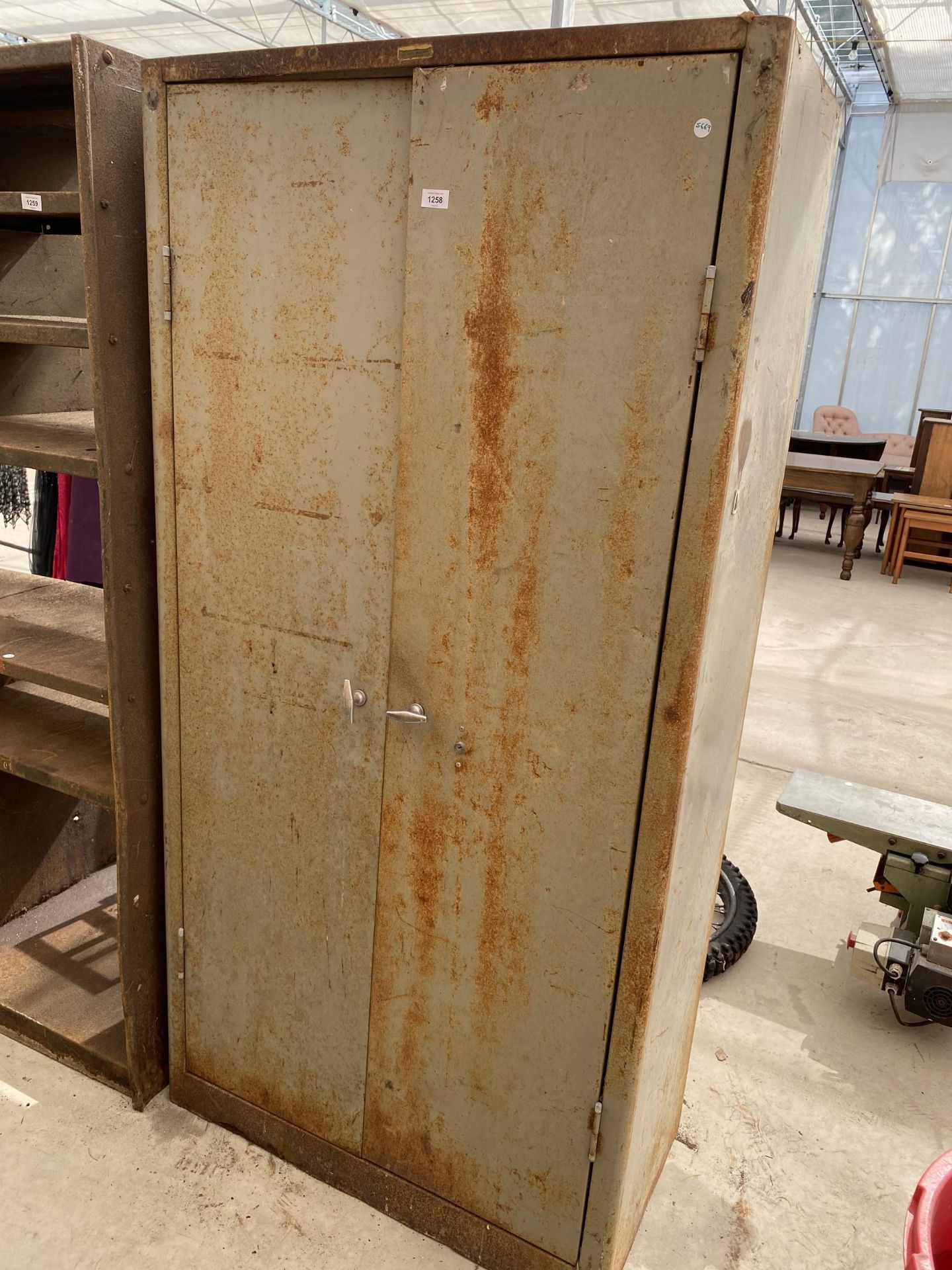 A VINTAGE METAL TWO DOOR STORAGE CUPBOARD