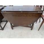 A REPRODUCTION OAK GATELEG DINING TABLE ON TURNED LEGS, BEARING LABEL EDGAR MALTBY AND SON, CHESTER,