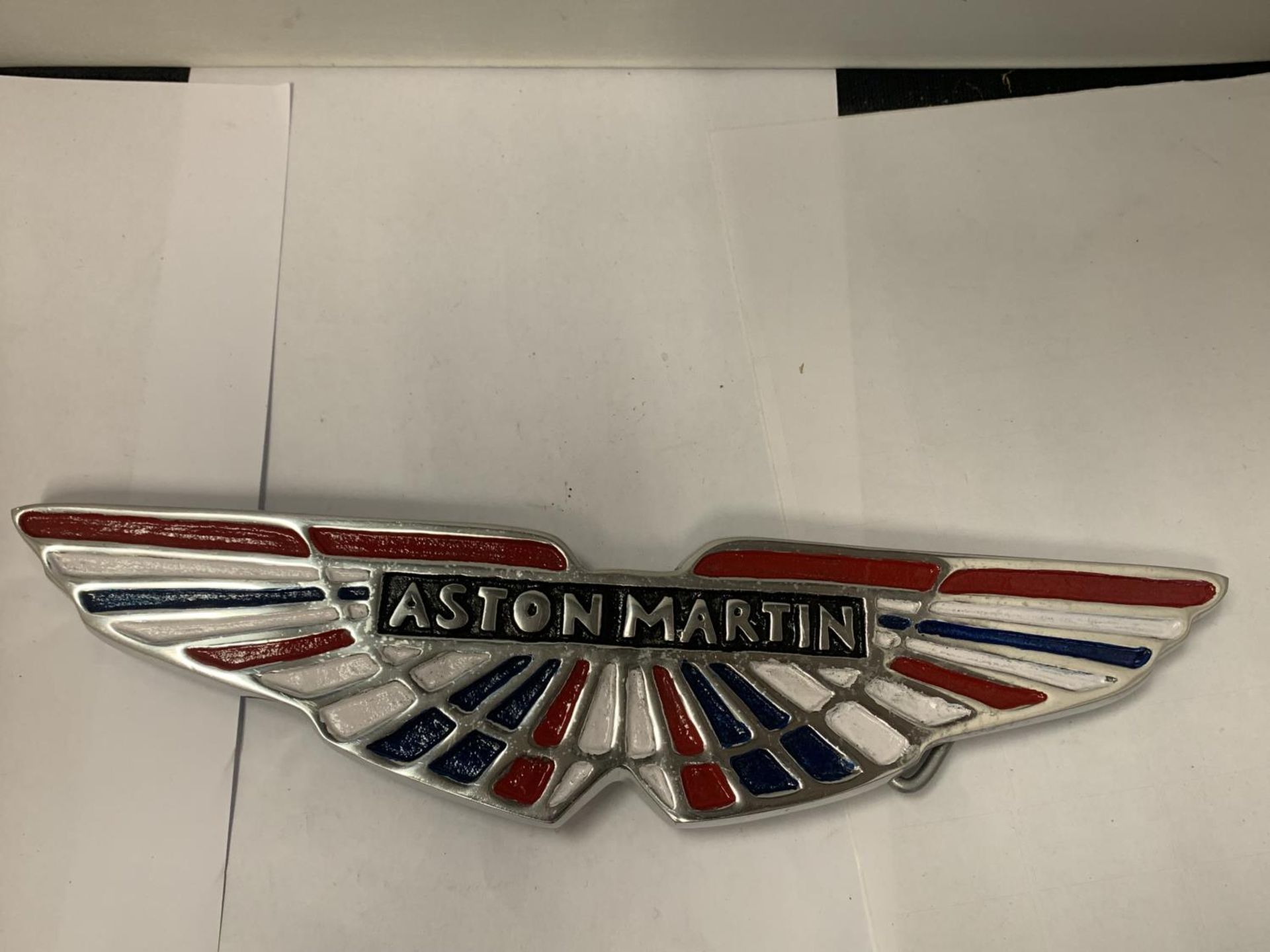 A CHROME 'ASTON MARTIN' SIGN