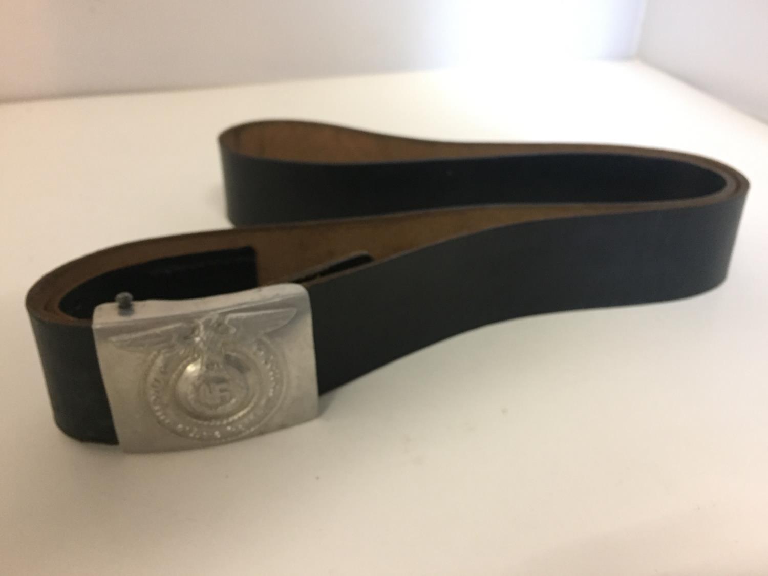 A GERMAN LEATHER BELT THE METAL BUCKLE WITH EAGLE AND SWASTIKA