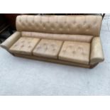 A 1970'S RETRO G.PLAN STYLE THREE SEATER BUTTON-BACK SETTEE WITH TEAK FRAME SHOWING TO THE FRONT