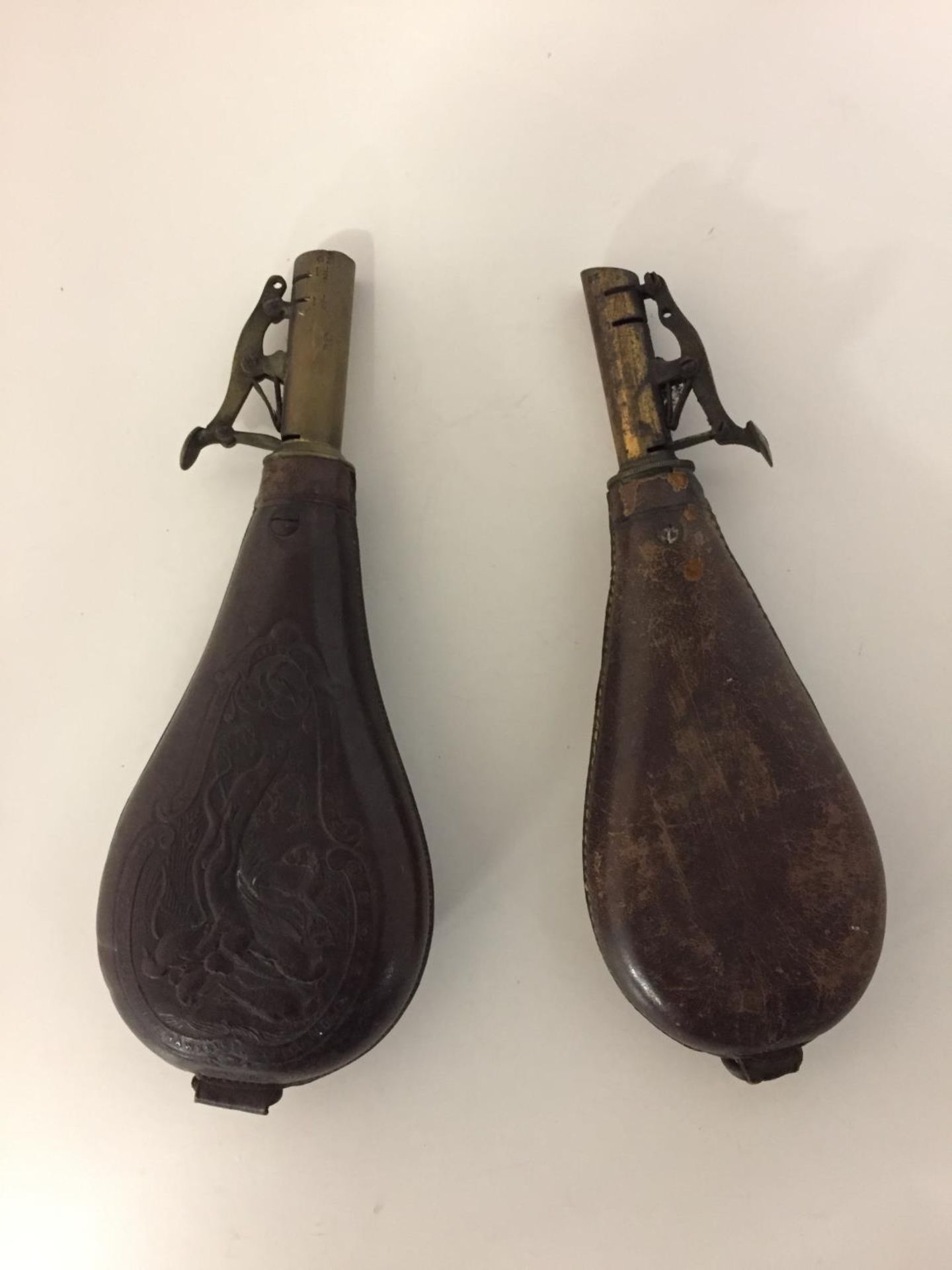 TWO LEATHER AND BRASS SHOT FLASKS
