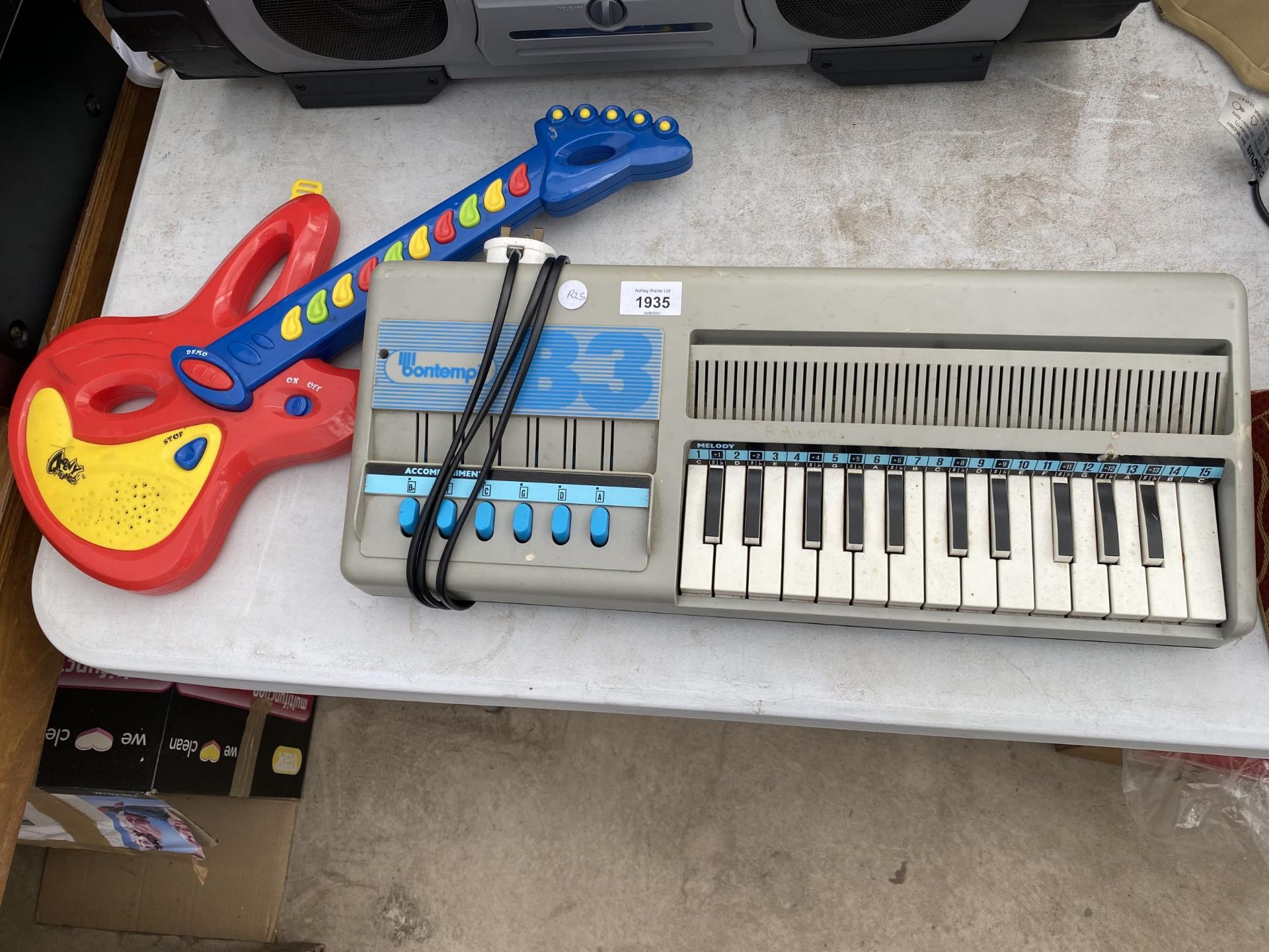 A BONTEMPI ELECTRIC KEYBOARD AND A CHILDRENS GUITAR