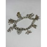 A SILVER CHARM BRACELET WITH SEVEN CHARMS TO INCLUDE A PRAM, BOOTS, PRAM ETC