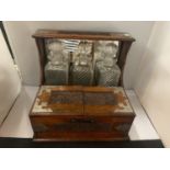 AN ORNATELY DECORATED AND ENGRAVED OAK ARTS AND CRAFTS STYLE TANTALUS/GAMING CABINET WITH THREE