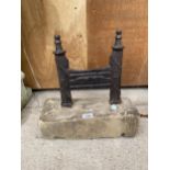 A VINTAGE BOOT SCRAPER SET IN A PIECE OF STONE