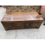 A MANGO WOOD COFFEE TABLE WITH FOUR DOUBLE SIDED DRAWERS WITH SCOOP HANDLES 22"X47"