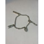 A SILVER BRACELET WITH THREE CHARMS AND A HEART PADLOCK