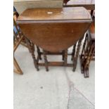 AN EARLY 20TH CENTURY OVAL OAK GATE-LEG DINING TABLE ON BARLEY TWIST LEGS 24" X 35"