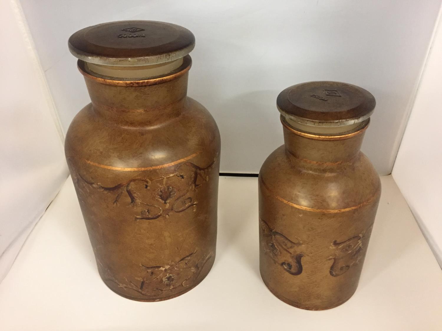 TWO VINTAGE DECORATED AMBER CLASS CONTAINERS WITH LIDS