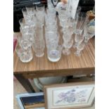 A LARGE ASSORTMENT OF CUT GLASS ITEMS TO INCLUDE BRANDY BALLOONS, SHERRY GLASSES AND TUMBLERS ETC