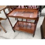 A REPRODUCTION MAHOGANY AND INLAID TWO TIER TROLLEY ON TURNED SUPPORTS 25.5" X 16"