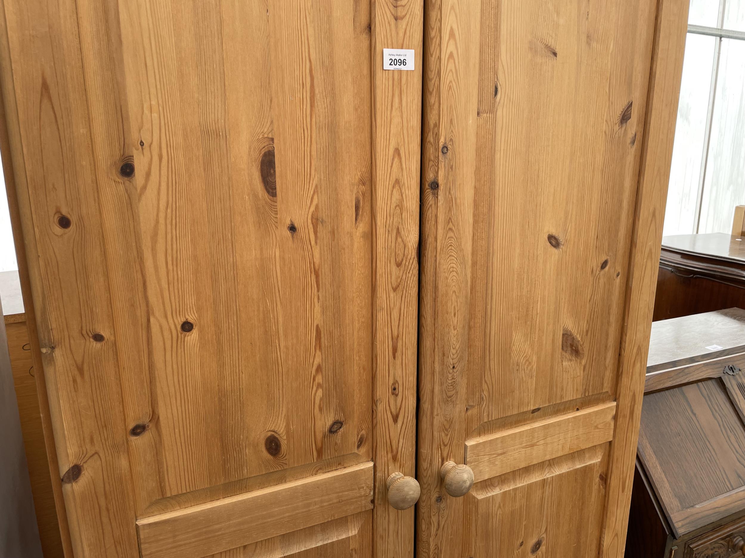 A MODERN PINE TWO DOOR WARDROBE WITH A DRAWER TO THE BASE AND TOP BOX 35" WIDE - Image 3 of 4