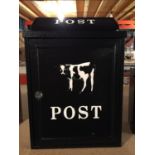 A BLACK WALL HANGING POST BOX WITH A FRESIAN CALF DESIGN