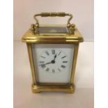 A BRASS CARRIAGE MANTLE CLOCK